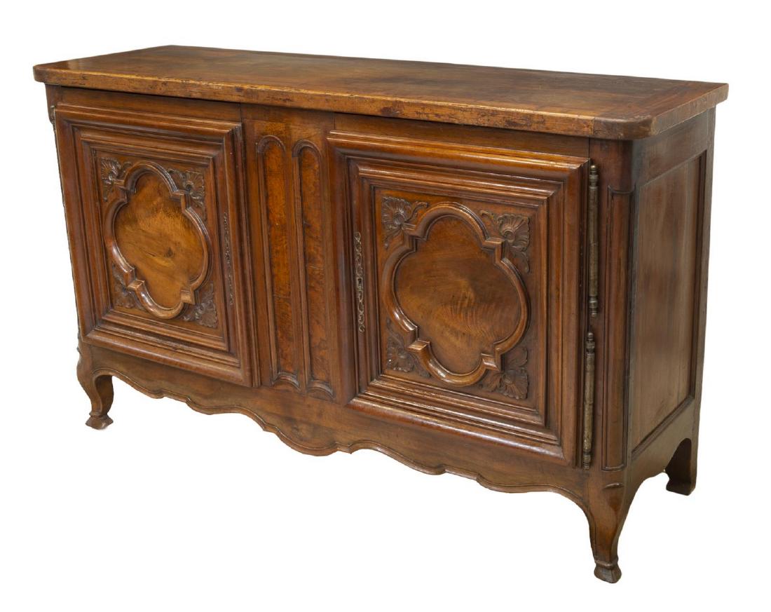 FRENCH REGENCE STYLE SIDEBOARD: French Regence style oak and walnut sideboard, 18th/19th c., rectangular case with a two paneled doors with raised accents opening to the shelved interior with two drawers, rising on hoof feet, approx