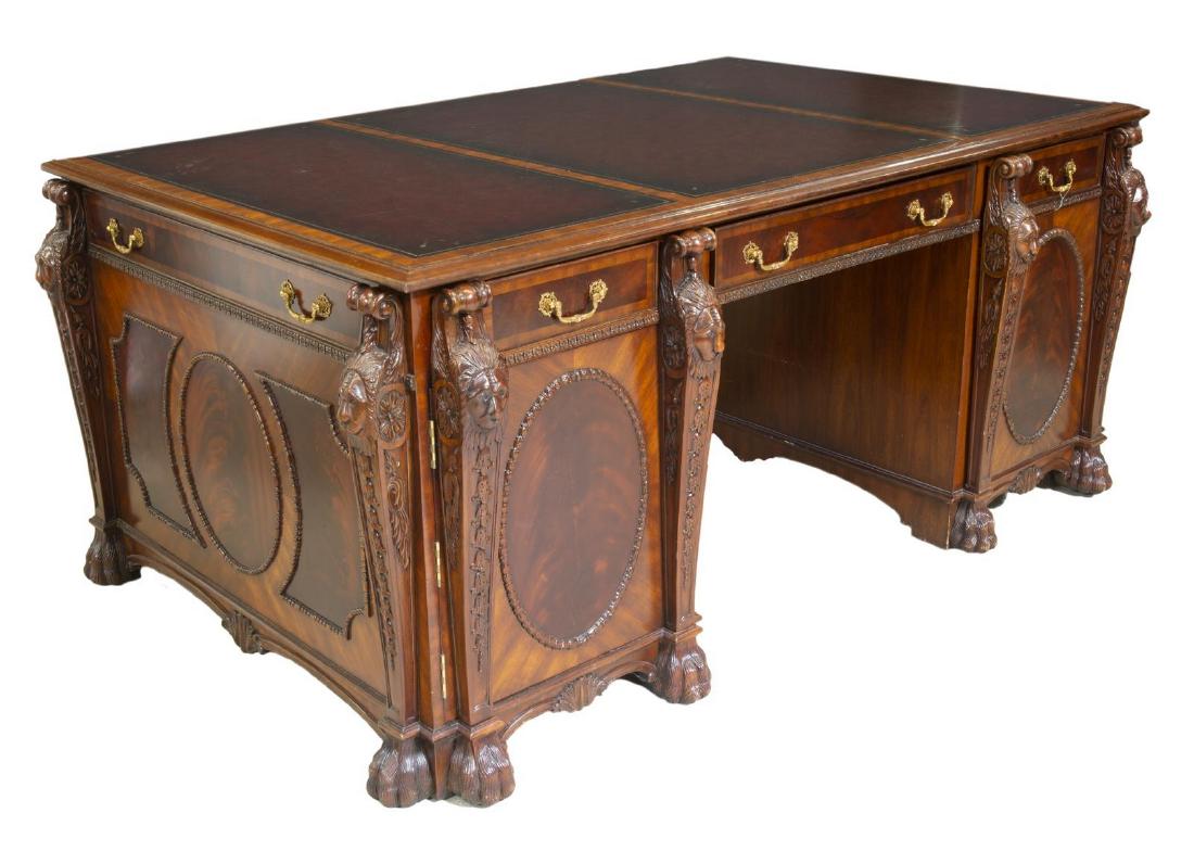 MAITLAND SMITH LEATHER-TOP MAHOGANY PARTNER'S DESK: Maitland Smith mahogany partner's desk, late 20th c., top with three inset leather panels with gilt embossed borders, over three frieze drawers to each side, cabinets flanking the kneehole, scrolled p