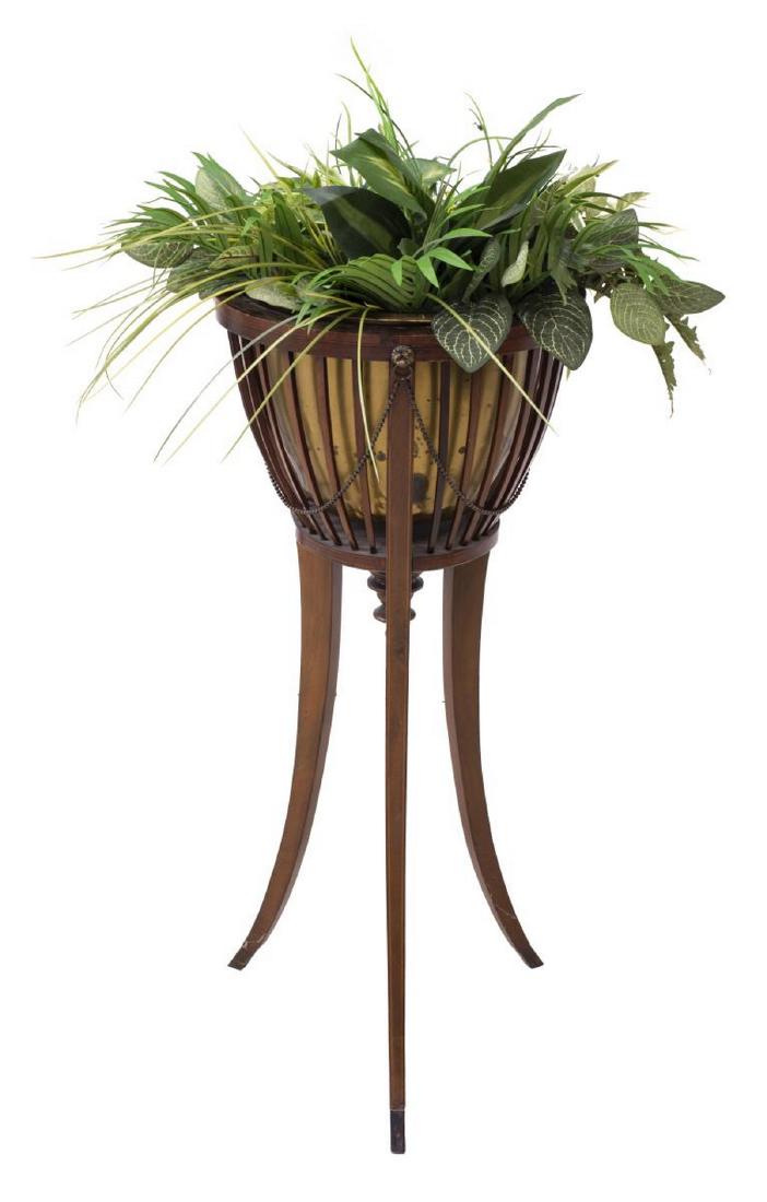 GEORGIAN STYLE MAHOGANY PLANTER STAND: Georgian style mahogany planter stand, 20th c., the circular open rib basket with pendant finial rising on three tapered saber legs with brass capped feet, approx 33"h,15"w, 15"d **Provenance: From th