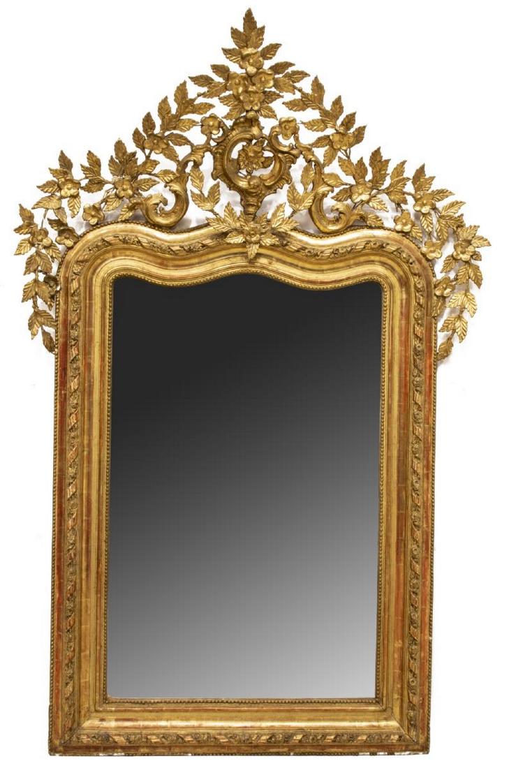 LARGE LOUIS XV STYLE ROCAILLE & SCROLL WALL MIRROR: French Louis XV style wall mirror, 19th c., the large, pierced crest with ornate rocaille and open work floral carving, running ribbon and beaded ornamentation surrounding a later flat mirror plate, s