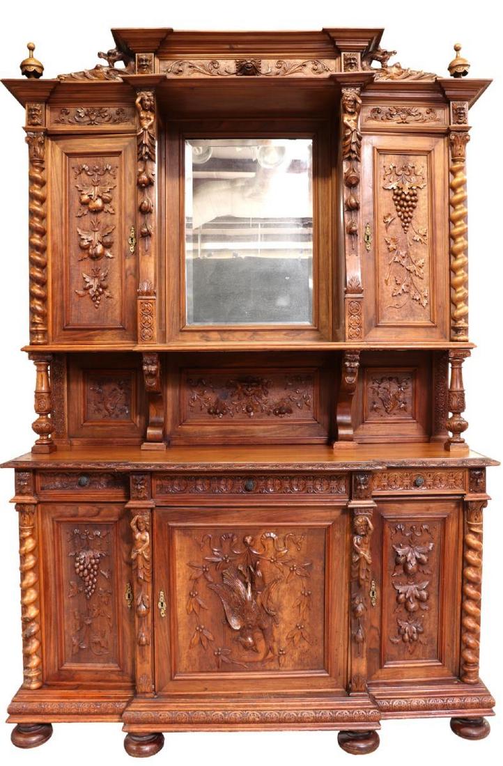 RENAISSANCE REVIVAL WALNUT HUNT SIDEBOARD: Continental Renaissance Revival walnut sideboard, late 19th c., turned finials over cornice top, carved frieze with masks and foliates in relief, figural pilasters centering open shelf with beveled mi