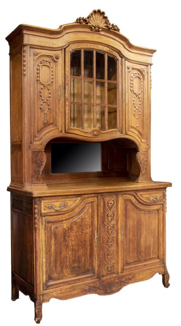 FRENCH LOUIS XV STYLE OAK SIDEBOARD DISPLAY: French Louis XV style oak sideboard display cabinet, early 20th c., the upper part with a carved shell cornice over the central multi-glazed pane door flanked by two floral carved face doors, descendi