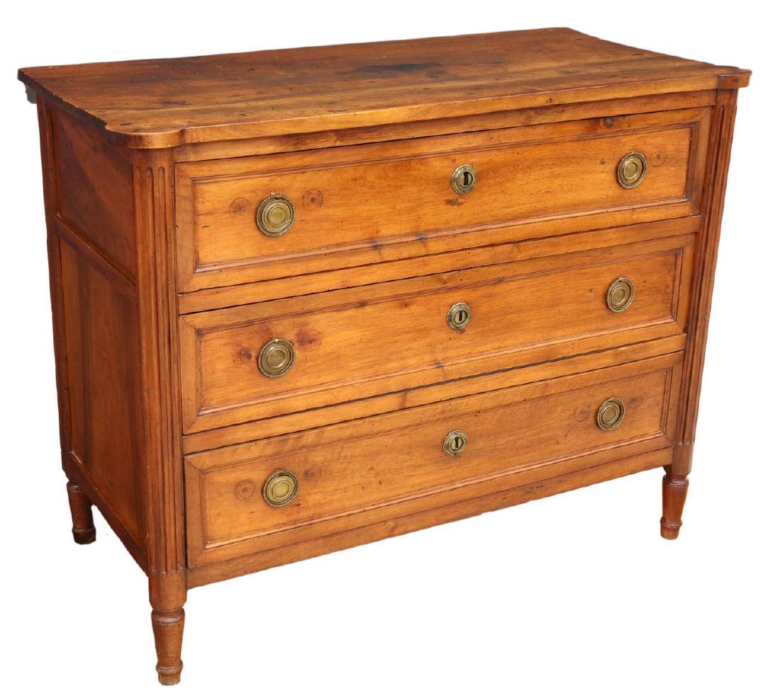 FRENCH LOUIS XVI STYLE THREE-DRAWER COMMODE: French Louis XVI style walnut commode, early 19th c., fitted with three drawers, flanking half columns, rising on tapered turned legs, approx 35.5"h, 44.75"w, 21.5"d Start Price: $600.00