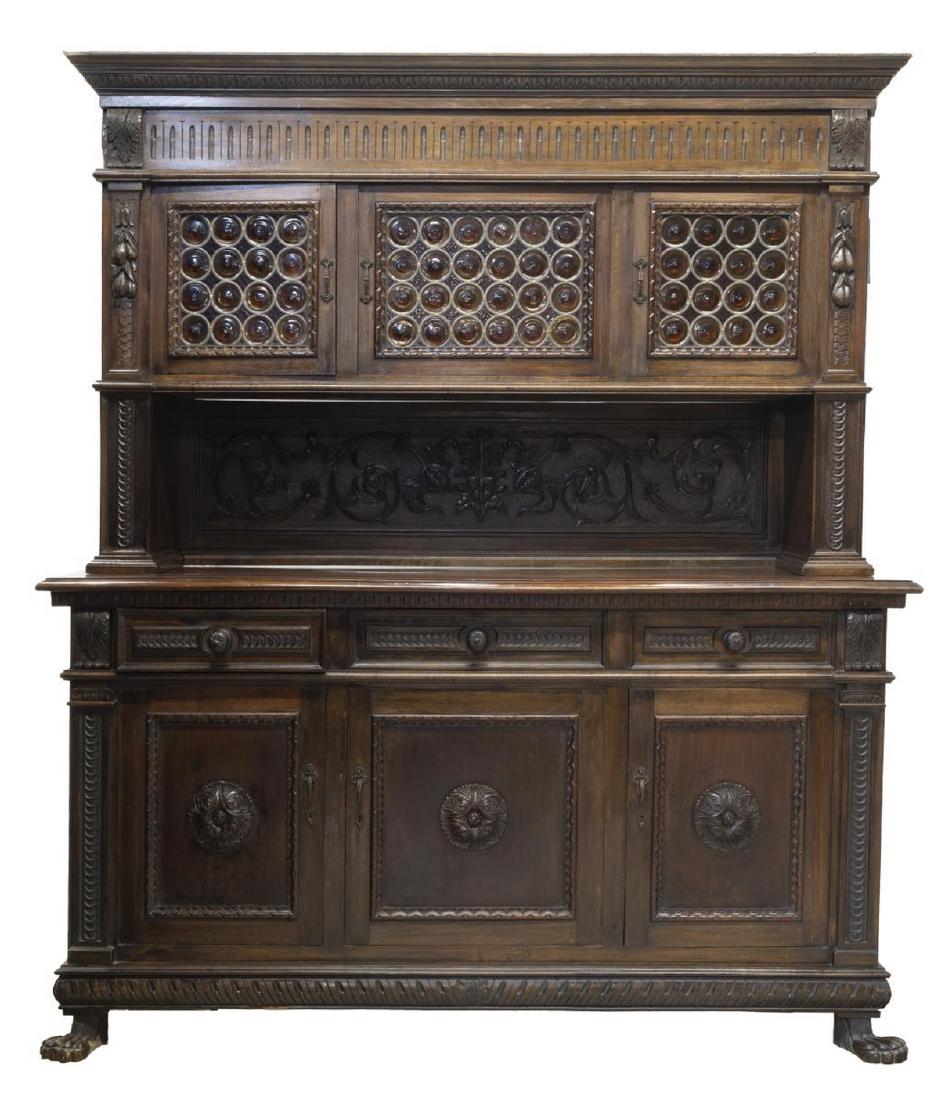RENAISSANCE REVIVAL CARVED WALNUT SIDEBOARD: Italian Renaissance Revival walnut sideboard, late 19th c., the cornice top with egg and dart molding, three cabinet doors with colored bull's eye glass glazing, over a backsplash carved in foliate re