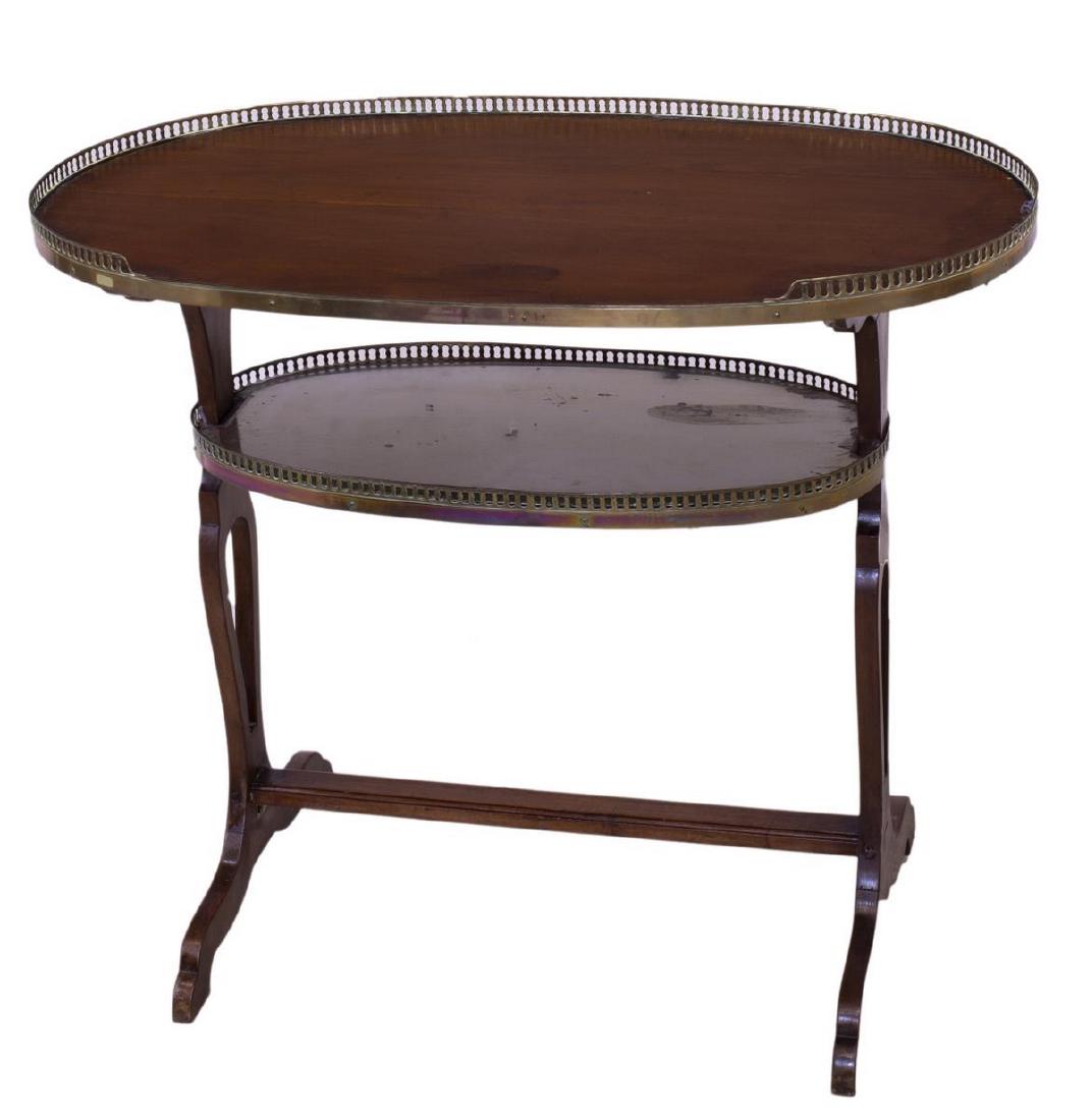 FRENCH LOUIS XVI STYLE MAHOGANY TWO-TIER TABLE: French Louis XVI style mahogany two-tier table, 20th c., having gilt metal pierced gallery wrapping partially around top shelf, lower mirrored glass shelf, rising on stretcher joined legs, approx 28.7