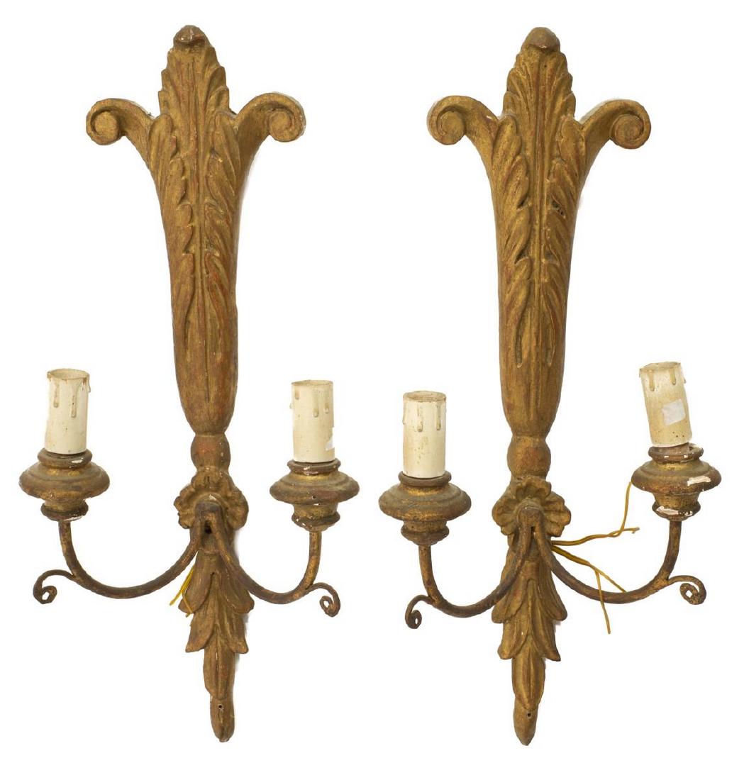 (PR) CONTINENTAL GILTWOOD SINGLE-LIGHT SCONCES: (pair) Continental giltwood single-light wall sconces, 20th c., having two lights within candle covers, each on single arm, extending from body with foliate and scrollwork shaping, in need of wiring, 