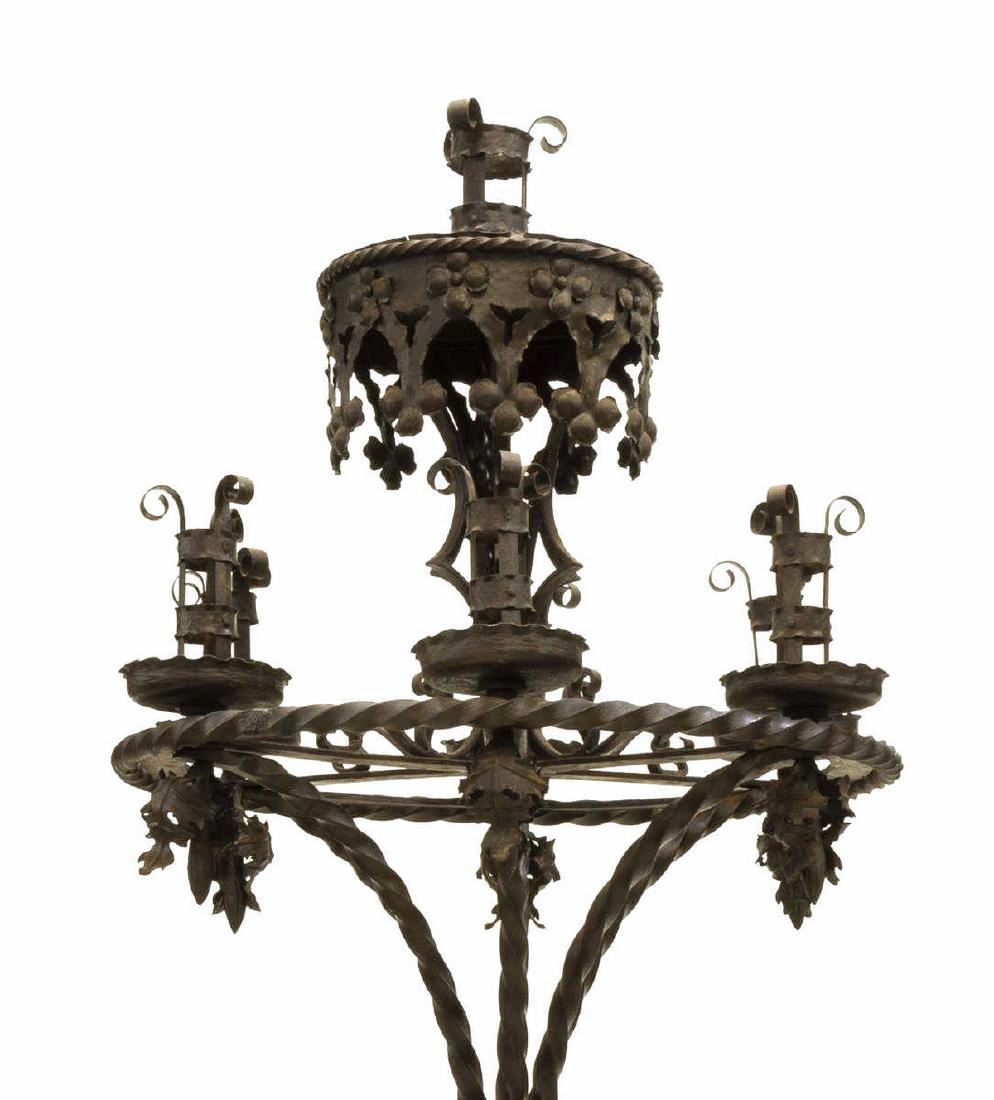 GOTHIC STYLE WROUGHT IRON FLOOR CANDELABRA, 81.5"H: Spanish Gothic Revival wrought iron floor candelabra, central raised candle well, over ring with six additional candle wells, drop foliate finials, twisted standards, tracery motifs throughout, buttre