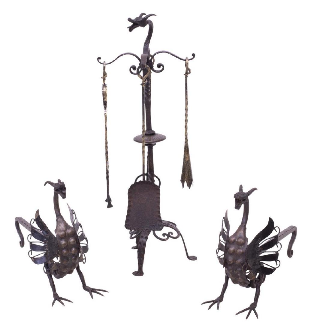 (2) AFTER ANTONIO GAUDI IRON FIREPLACE SET: (lot of 2) Iron fireplace set, 19th/20th c., in the manner of Antonio Gaudi (Spain, 1852-1926), including: (1) pair of andirons, with dragons at ends, 12.75"h, 19.5"w, 6.75"d; (1) set of fireplace too