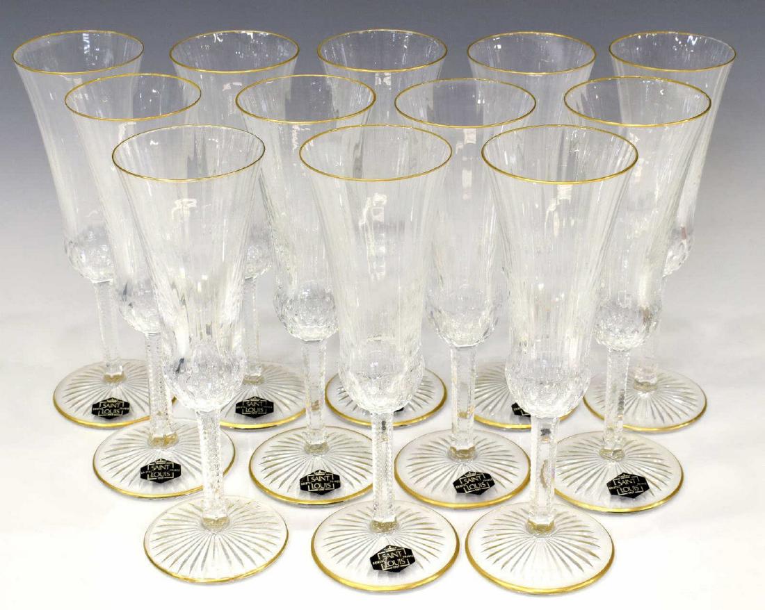 12)SAINT LOUIS APOLLO GOLD CRYSTAL CHAMPAGNE STEMS: (lot of 12) Saint Louis Crystal champagne flutes, in the "Apollo Gold" pattern, the body and stem with subtle rib design, lip and foot with gold banded highlights, acid etched stamp, "Cristal St. Loui