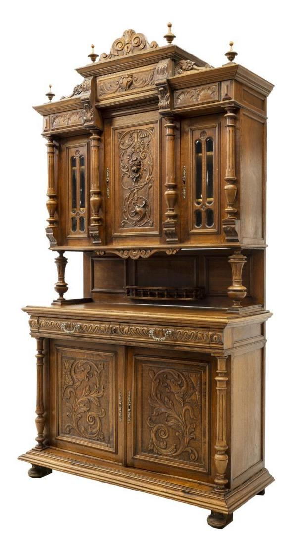 LARGE FRENCH CARVED SIDEBOARD SERVER, 19THC.: Large French carved oak cupboard, late 19th c., accented with floral, ribbon and griffin carving, the doors separated by turned ribbed columns, the upper part a central door flanked at each side by gl