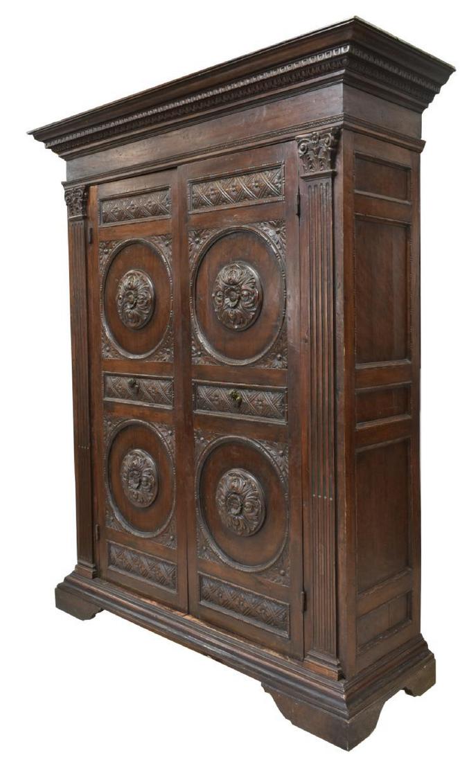 ITALIAN RENAISSANCE REVIVAL CARVED ARMOIRE: Italian Renaissance Revival armoire, 18th/19th c., the stepped cornice with running ornamentation, above double doors having carved floral and rosette motifs, accented by figural form metal handles, f