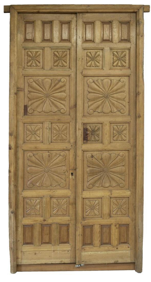 (2) ARCHITECTURAL SPAIN PANELED PINE DOORS: (lot of 2) Antique architectural paneled pine doors, Spain, with carved stylized floral medallions, (one) door with iron slide latches, (one) door lacking escutcheon and key lock hardware, each door: 