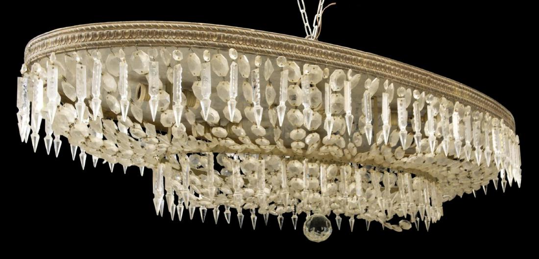 LARGE ITALIAN CRYSTAL 12-LIGHT CEILING CHANDELIER: Italian crystal twelve-light chandelier, 20th c., having two tiers with crystal of various shapes hanging from metal bands, accented by running ornamentation, with drape between tiers, twelve lights w