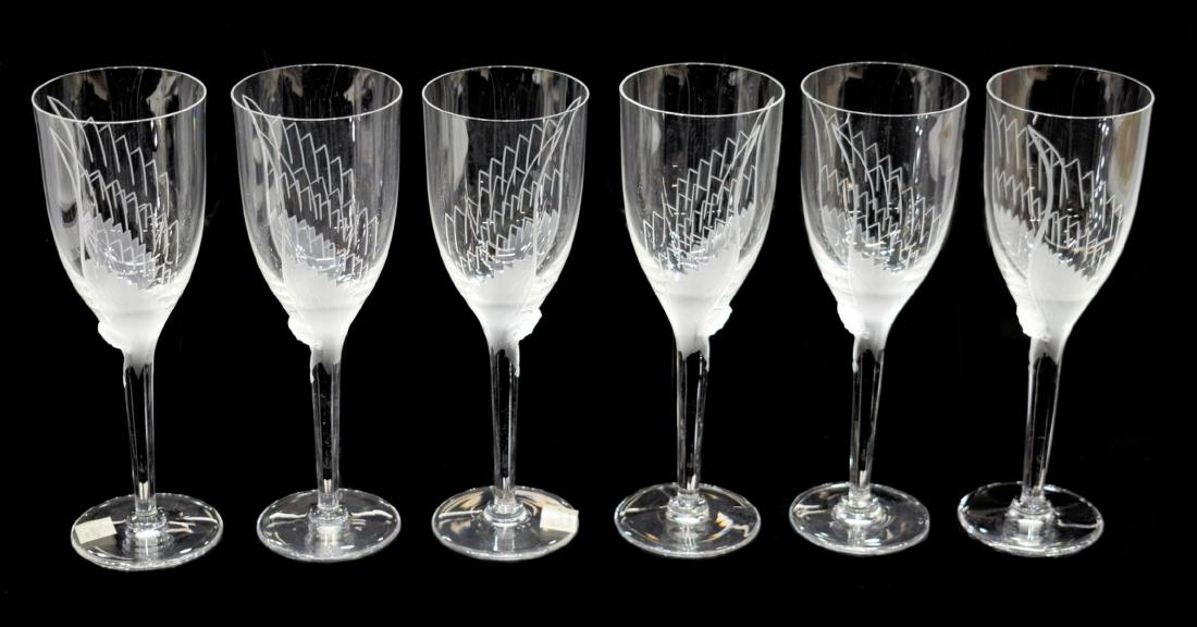 (6) LALIQUE FRANCE 'ANGE' CRYSTAL CHAMPAGNE FLUTES: (lot of 6) Lalique, France "Ange" art crystal champagne flutes, having cup accented by frosted glass wings rising from molded angel's face at top of stem, resting on round foot, two retaining retail s