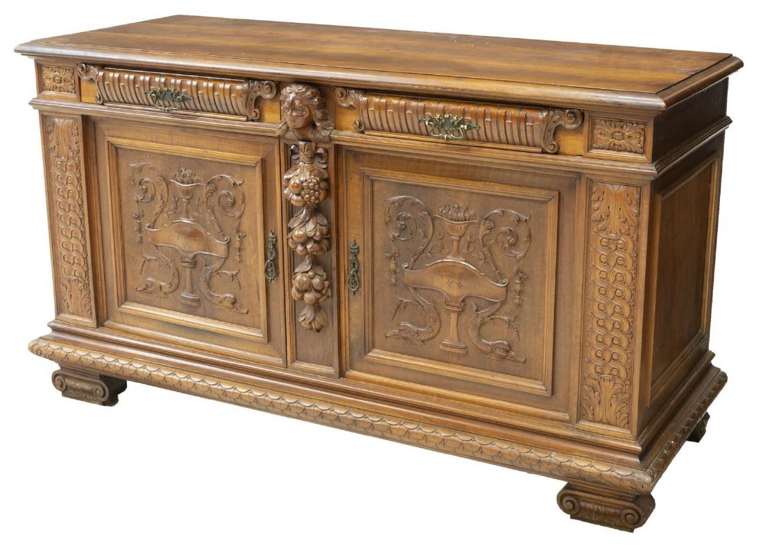 ITALIAN RENAISSANCE REVIVAL WALNUT SIDEBOARD: Italian Renaissance Revival walnut sideboard, early 20th c., having running ornamentation, foliate, fruit, urn and figural carving, accented by intricate hardware, two drawers above two single door ca
