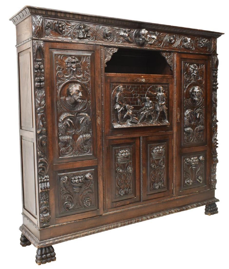 SPANISH RENAISSANCE REVIVAL WALNUT SECRETARY: Spanish Renaissance Revival walnut secretary bookcase, early 20thc., elaborately carved carved figural relief scenes of mythical beasts and foliage, the fall front secretary showing a figural scene of