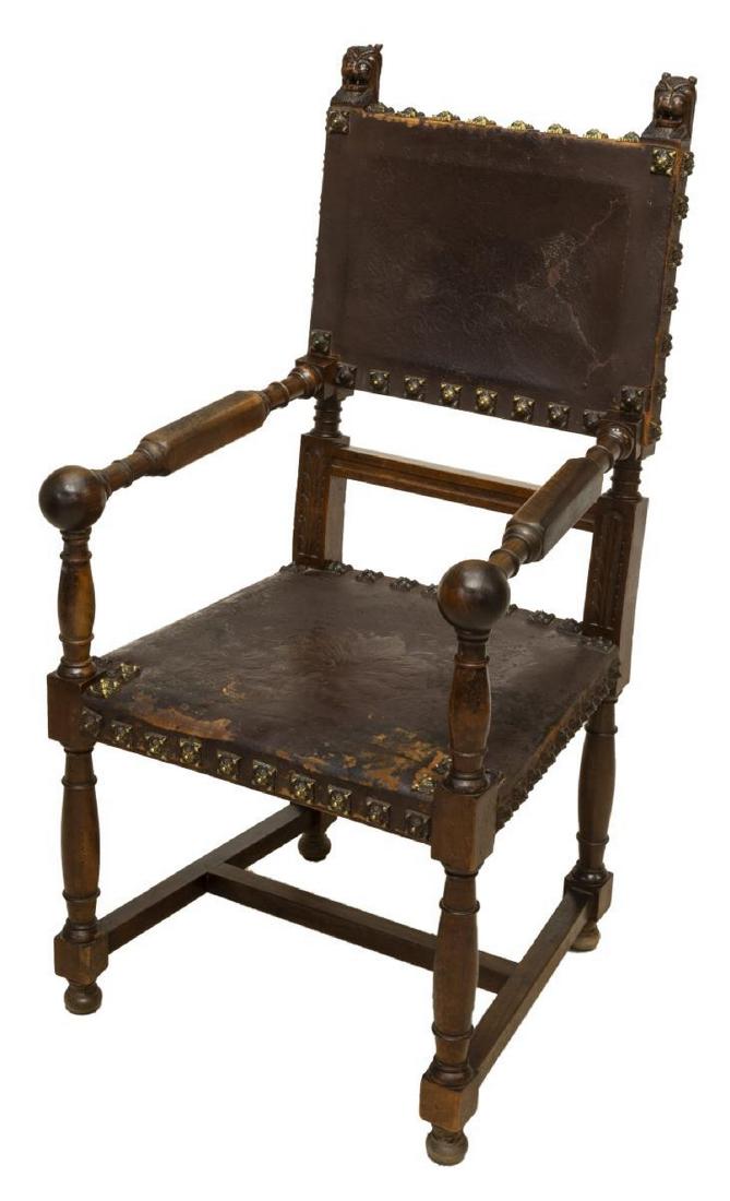 SPANISH RENAISSANCE REVIVAL LEATHER ARMCHAIR: Spanish Renaissance Revival walnut armchair, 19th c., carved lion mask ears, worn embossed leather back and seat, with decorative nail head trim, turned arms ending in ball handholds, rising on turned
