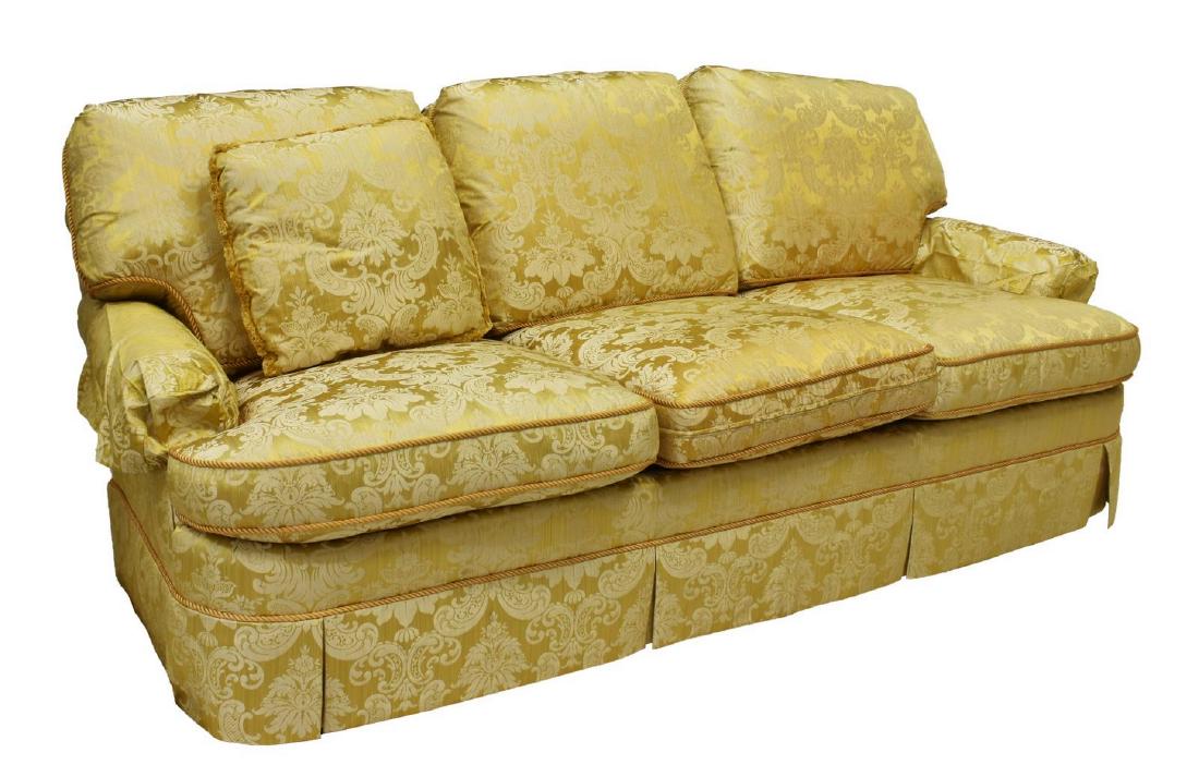 BAKER FURNITURE THREE-SEAT LOOSE BACK SOFA: Baker Furniture three-seat sofa, late 20th c., in damask upholstery (some silk content), having loose back and seat cushions, rolled arms with optional covers, skirted base concealing tapered block fe