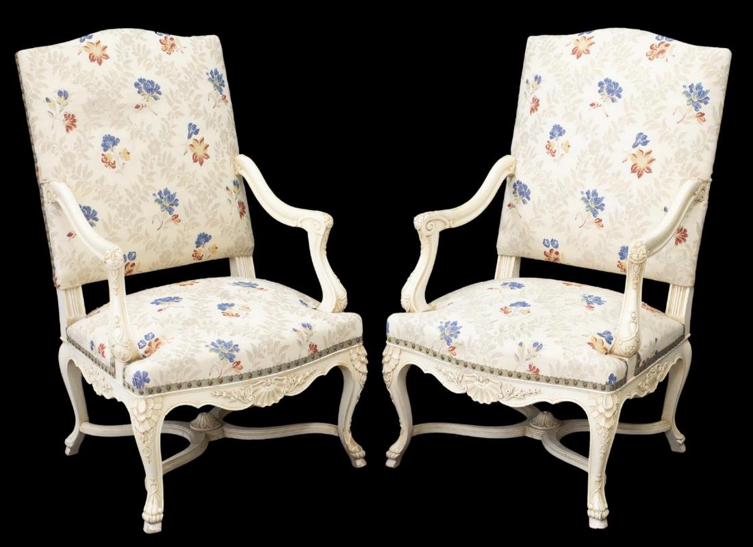 (2) FRENCH LOUIS XV STYLE PAINTED FAUTEUILS: (pair) French Louis XV style armchairs, 20th c., off-white painted frames, tall back in floral upholstery, reverse with contrasting striped textile, with ribbon and nail head trims, arms ending in scr