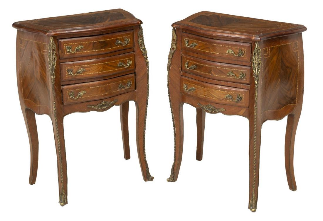 (PAIR) ITALIAN LOUIS XV STYLE NIGHTSTANDS: (pair) Italian Louis XV style nightstands, 20th c., in matched rosewood and mahogany veneers, contrasting string inlay, fitted with three drawers, rising on French bracket feet, with gilt metal corner