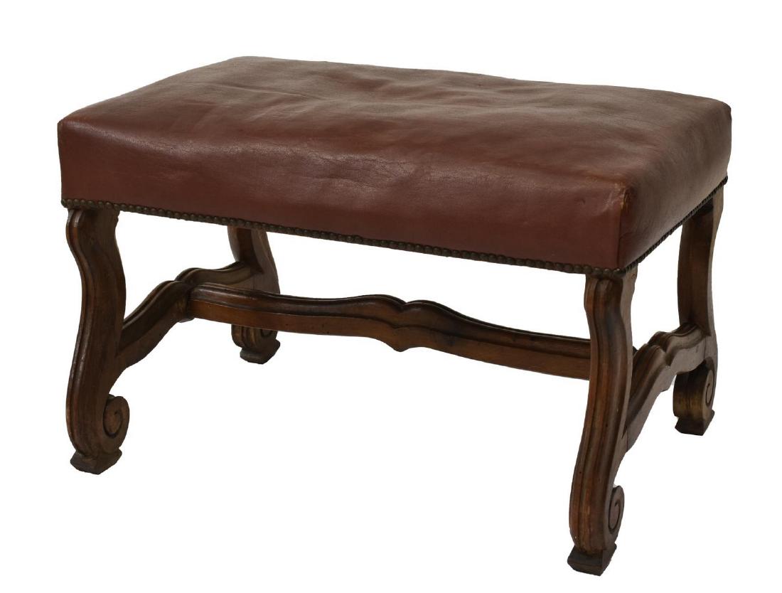 SPANISH BAROQUE STYLE UPHOLSTERED BENCH, 20TH C.: Spanish Baroque style upholstered walnut bench, 20th c., the upholstered top with brass tacking, rising on stretcher joined ox yoke legs, approx 16"h, 24"w, 16"d Start Price: $100.00