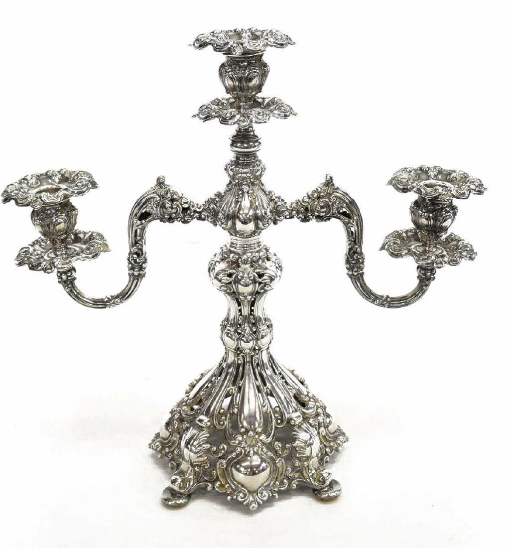 REED & BARTON RENAISSANCE SILVERPLATE CANDELABRA: Reed & Barton "Renaissance" silverplate three-light candelabra, rocaille stem on reticulated lobed base, two reticulated and foliate scrolled arms, surmounted by a floral-shaped cups with matching bob