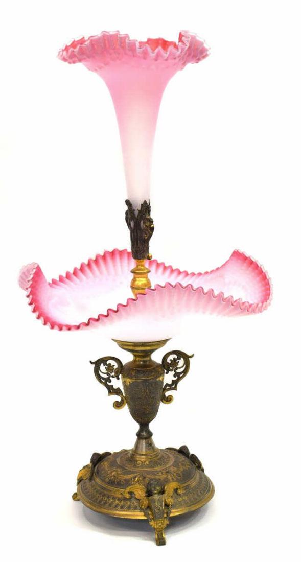 VICTORIAN PINK SATIN RUFFLED ART GLASS EPERGNE: Victorian pink satin art glass epergne, late 19th/ early 20th c., the single ruffled flute over a shaped dish, rising on a remnants of gilt a gilt finish to metal base with a fruited pattern and putti