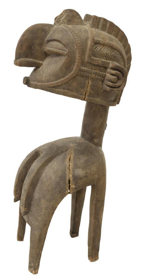 AFRICAN CARVED TRIBAL BIRD NIMBA SHOULDER MASK: Large tribal hardwood carved bird Nimba shoulder mask, Baga tribe, Africa, headdress adorned atop, closed eyes, protruding beak, thin neck bellowing out to curved base with four legs, cross hatched an