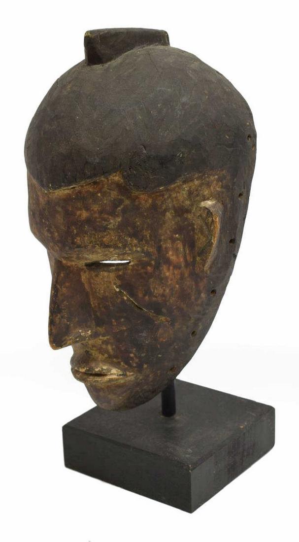HAND CARVED AFRICAN HARDWOOD MASK: Tribal mask, Africa. carved wood, slit eyes hole, two marks under eyes, long nose, pursed lips, custom stand included approx 4"h, 7.5"w, 22"diam Start Price: $50.00