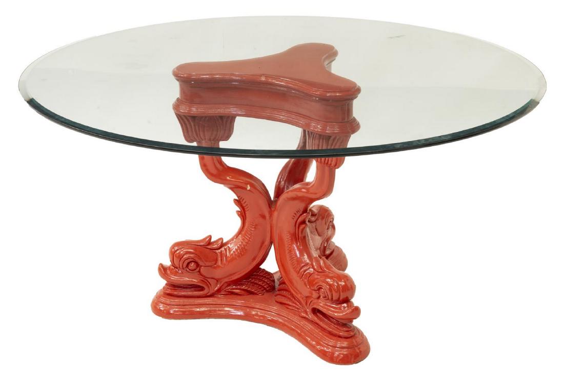 PAINTED STONE DOLPHIN PEDESTAL TABLE, 20TH C.: Cast and painted stone pedestal table, 20th c., the circular glass top over a bright red shaped base with three dolphins, approx 28.5"h, 54.25"diam Start Price: $100.00