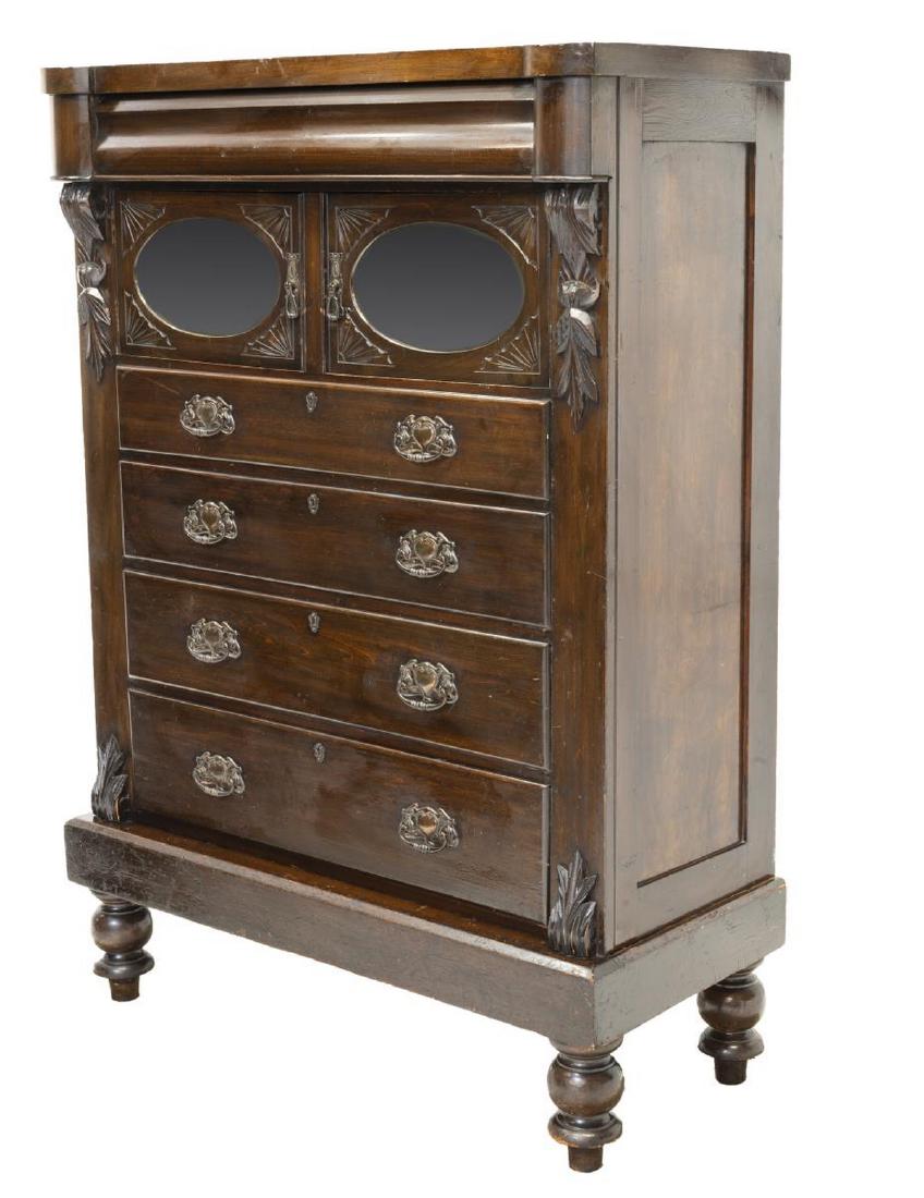 EDWARDIAN MIRRORED CHEST OF DRAWERS: Edwardian chest of drawers, late 19th/ early 20th c., the rectangular top above a frieze drawer appearing as trim, over two cabinet doors with beveled mirrors, all over four drawers, having carved fol