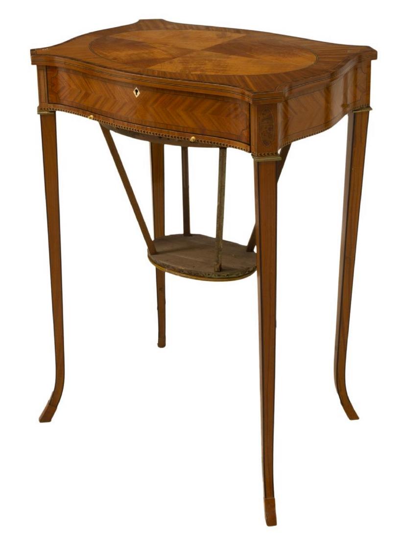 ENGLISH MAHOGANY & SATIN WOOD SEWING WORK TABLE: English mahogany and satin wood sewing table, late 19th/ early 20th c., cartouche-shaped top over conforming apron, contrasting string inlay, burl medallions at corners, single frieze drawer with fitt