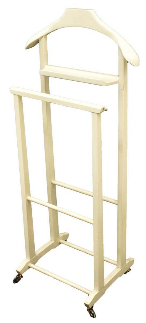 ITALIAN MID-CENTURY MODERN GENTLEMAN'S VALET: Italian mid-century modern gentleman's valet stand, c. 1950s, manufactured by Fratelli Reguitti, in later white paint, with coat hanger, accessories tray, and trouser rail, trestle base on casters, ap