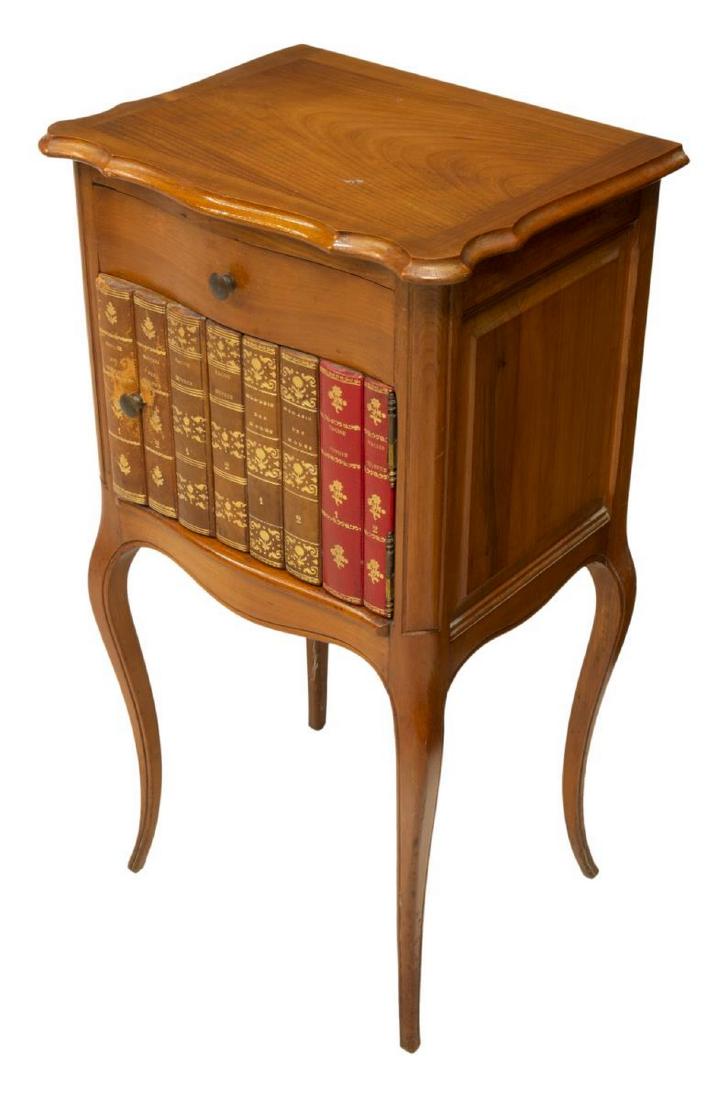 FRENCH LOUIS XV STYLE FRUITWOOD NIGHTSTAND: French Louis XV style fruitwood nightstand, 20th c., having shaped top, case fitted with drawer over cabinet door faced with leather book spines, rising on slim cabriole legs, approx 29.25"h, 15.25"w,