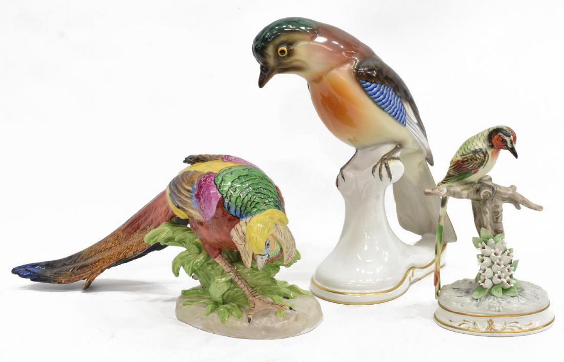 (3) PORCELAIN BIRDS, CARL THIEME, BEHSCHERZER: (lot of 3) Porcelain bird figures, including: (1) Bavarian porcelain jaybird, Behscherzer, depicted perched on branch, over parcel gilt base, marked underfoot, approx 11.25"h, 4"w, 7"d, (1) Dresden po