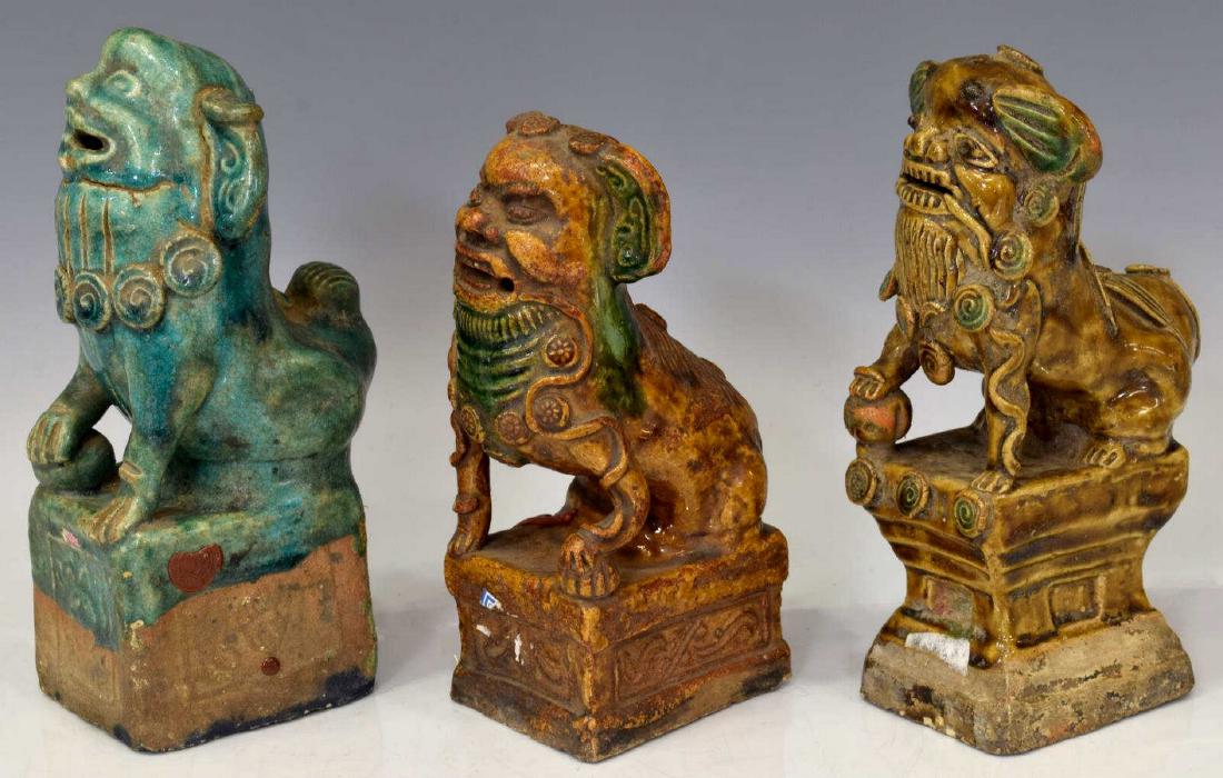 (3) COLLECTION OF CHINESE GLAZED CLAY FOO DOGS: (lot of 3) Chinese glazed clay foo dogs, in varied styles, each posed on base, (2) in brown tones, (1) in green tone, all retaining seal, one with several cracks, two with loss, largest: approx 8.25"h