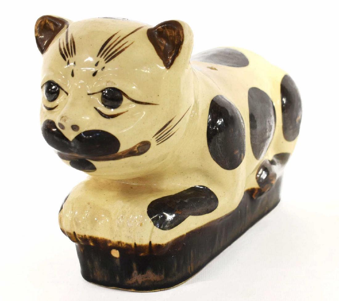 CHINESE CAT FORM FIGURAL CERAMIC PILLOW: Chinese ceramic pillow, in the shape of a cat, having white body with brown spots, retaining seal to back, some crazing and chips to glaze, approx 7.5"h, 5"w, 13"d, 5.25lbs Start Price: $50.00