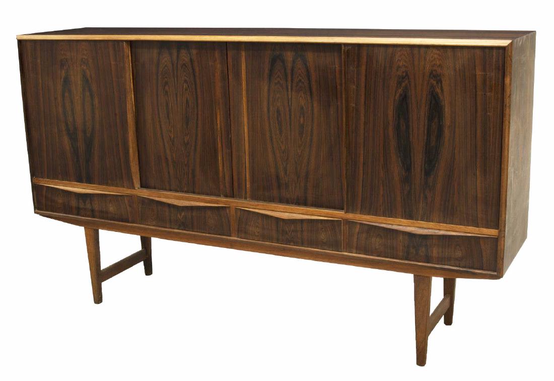 DANISH MID-CENTURY MODERN ROSEWOOD SIDEBOARD: Danish mid-century modern rosewood sideboard, c.1960s, rectangular case with four sliding doors opening to shelves and drawers, all over four drawers, rising on stretcher-joined tapered squared legs, 
