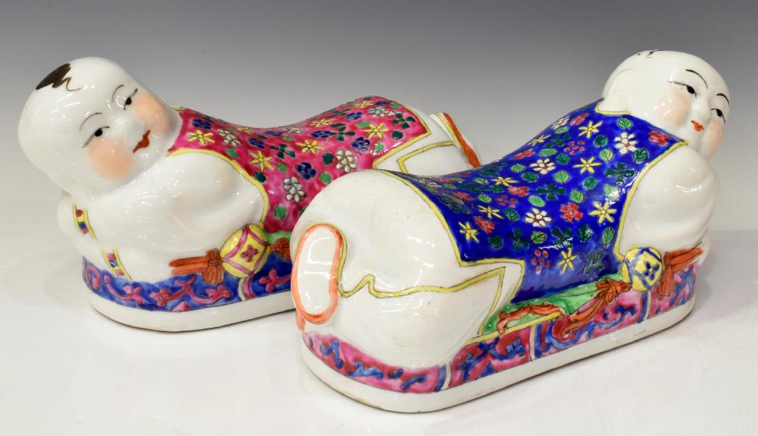 (2) CHINESE FAMILLE ROSE PORCELAIN FIGURAL PILLOWS: (lot of 2) Chinese famille rose porcelain pillows, each modeled as a child in a reclined position, approx 5.25"h, 10.75"w, 4.5"d; 4.75lbs total Start Price: $50.00
