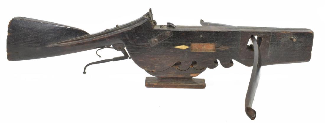 ANTIQUE WOOD & IRON CROSSBOW, 17TH / 18TH C.: Antique crossbow, likely German, 17th/18th c., having an iron prod or bow (30.5"long, 5.10lbs), iron lock and iron reinforcing on the wood frame, adjustable iron rear sight, two of six remaining bone 