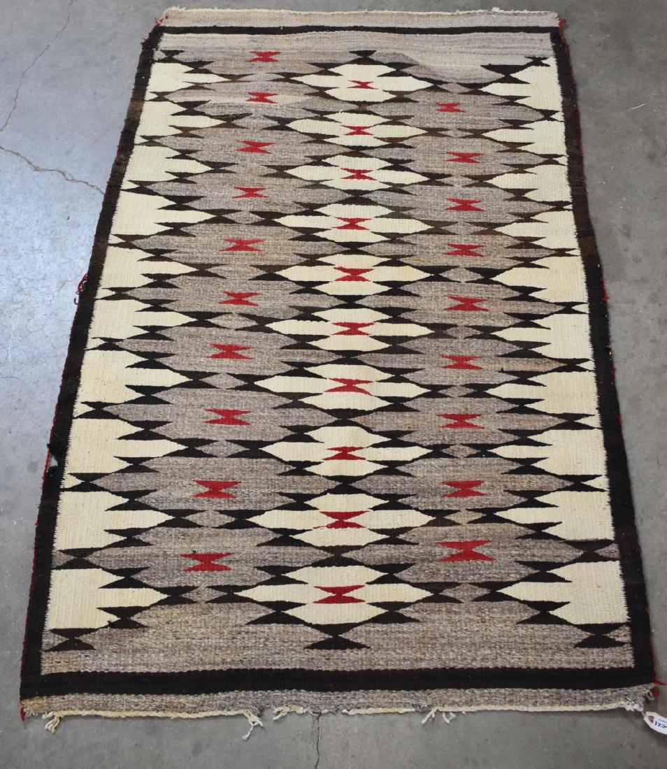 NAVAJO NON-REGIONAL EYE DAZZLER RUG, 4'5" X 2'10": Navajo non-regional eye dazzler rug, mid 20th c. restoration to one corner, two holes near edge binding, tear at one end, fraying and unraveling to corners, approx 4'5"l, 2'10"w Start Price: $100.00