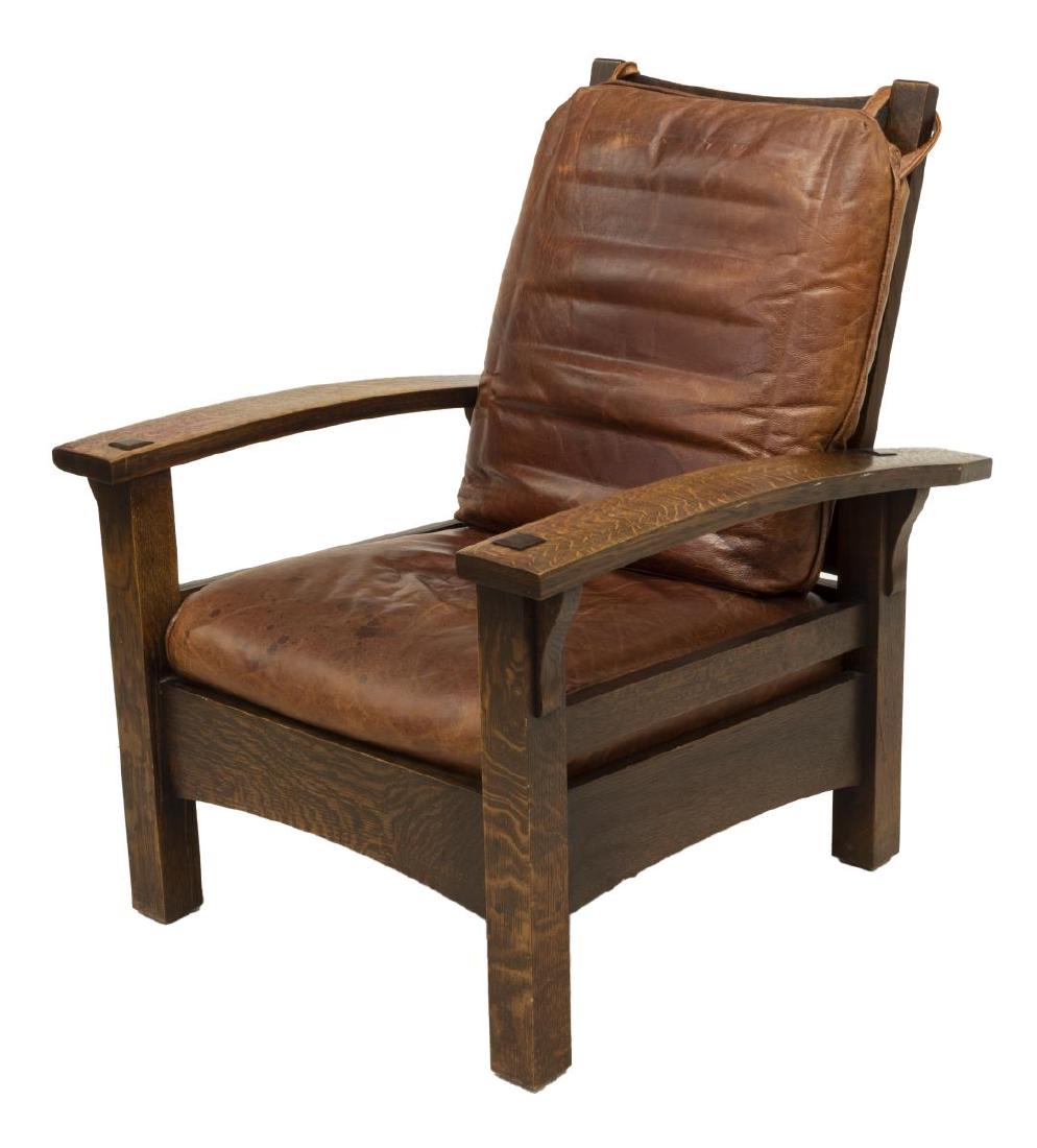CRAFTSMAN STYLE OAK RECLINING ARMCHAIR: Arts and Crafts style oak reclining armchair, in the manner of Gustav Stickley (United States, 1858-1942), case with wide back and arms, front leg piercing through the arched arm with it's pinned thro