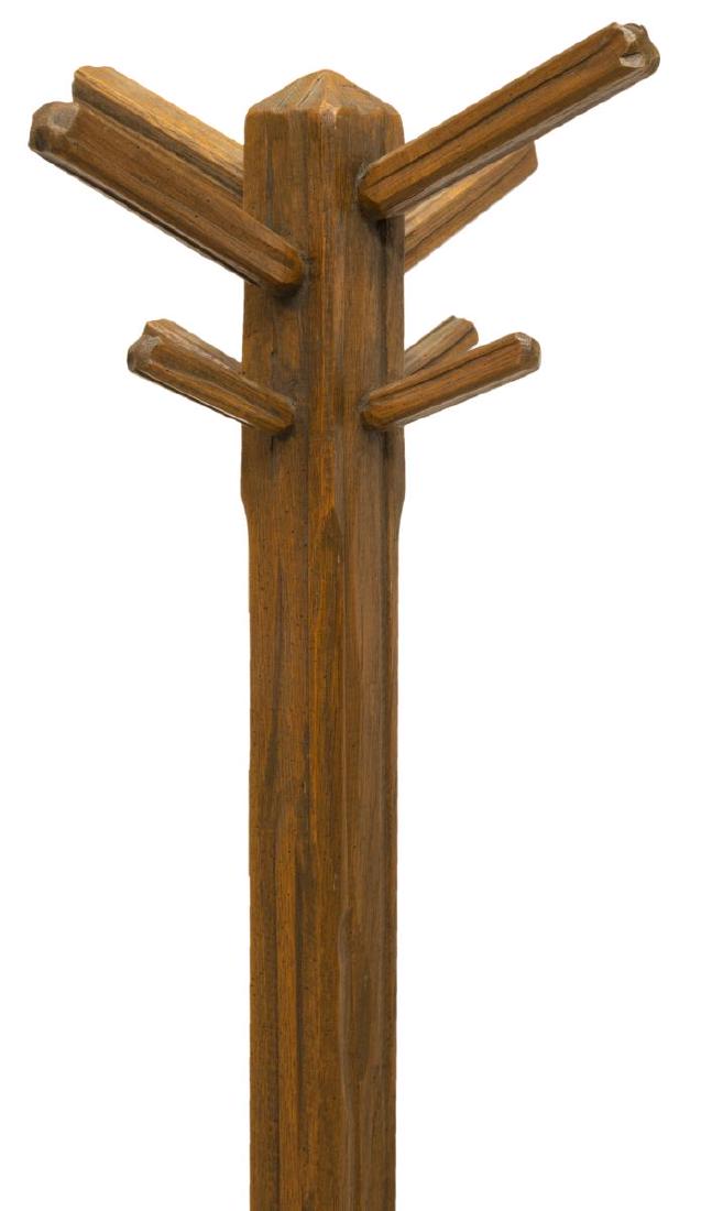 CRAFTSMAN STYLE CARVED OAK STANDING COAT RACK: Large craftsman style carved oak standing coat rack, featuring eight hooks on base with pierced geometric design throughout, rising on four tripod style legs, approx 67"h Start Price: $50.00