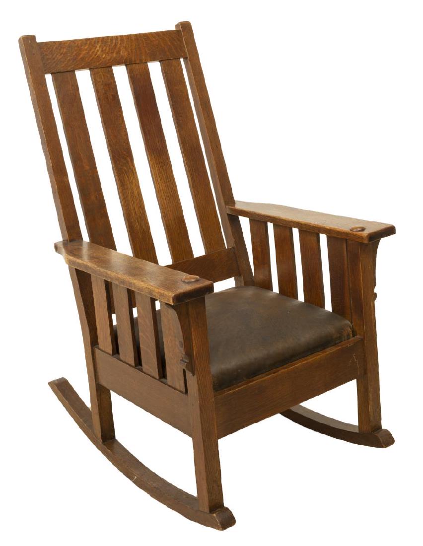 AMERICAN CRAFTSMAN OAK ROCKING CHAIR: American Arts and Crafts oak rocking chair, having slatted back, wide armrests flanking drop in cushion seat, on rocker rails, marked G&P F under seat, approx 43.5"h, 27.25"w, 32.75"d Start Price: $10