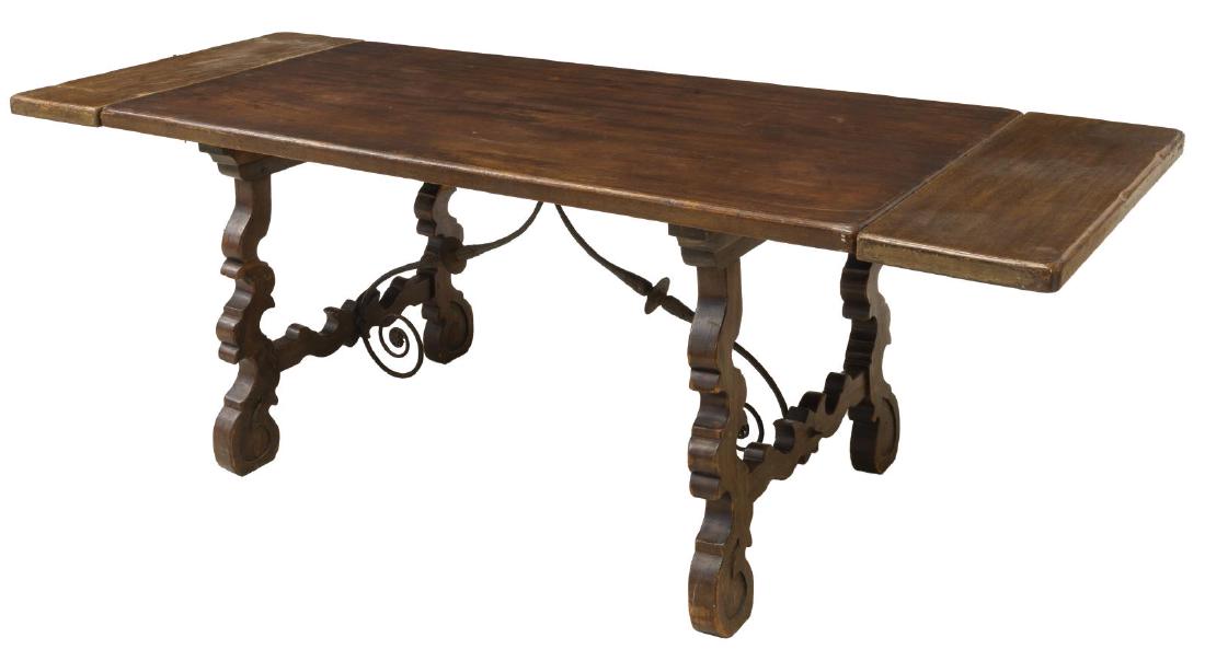 SPANISH BAROQUE STYLE EXTENSION DINING TABLE: Spanish Baroque style extension dining table, 20th c., having single plank top, rising on trestle base joined by scrolled iron stretchers with foliate accent, accompanied by two leaves, approx 29.5"h,