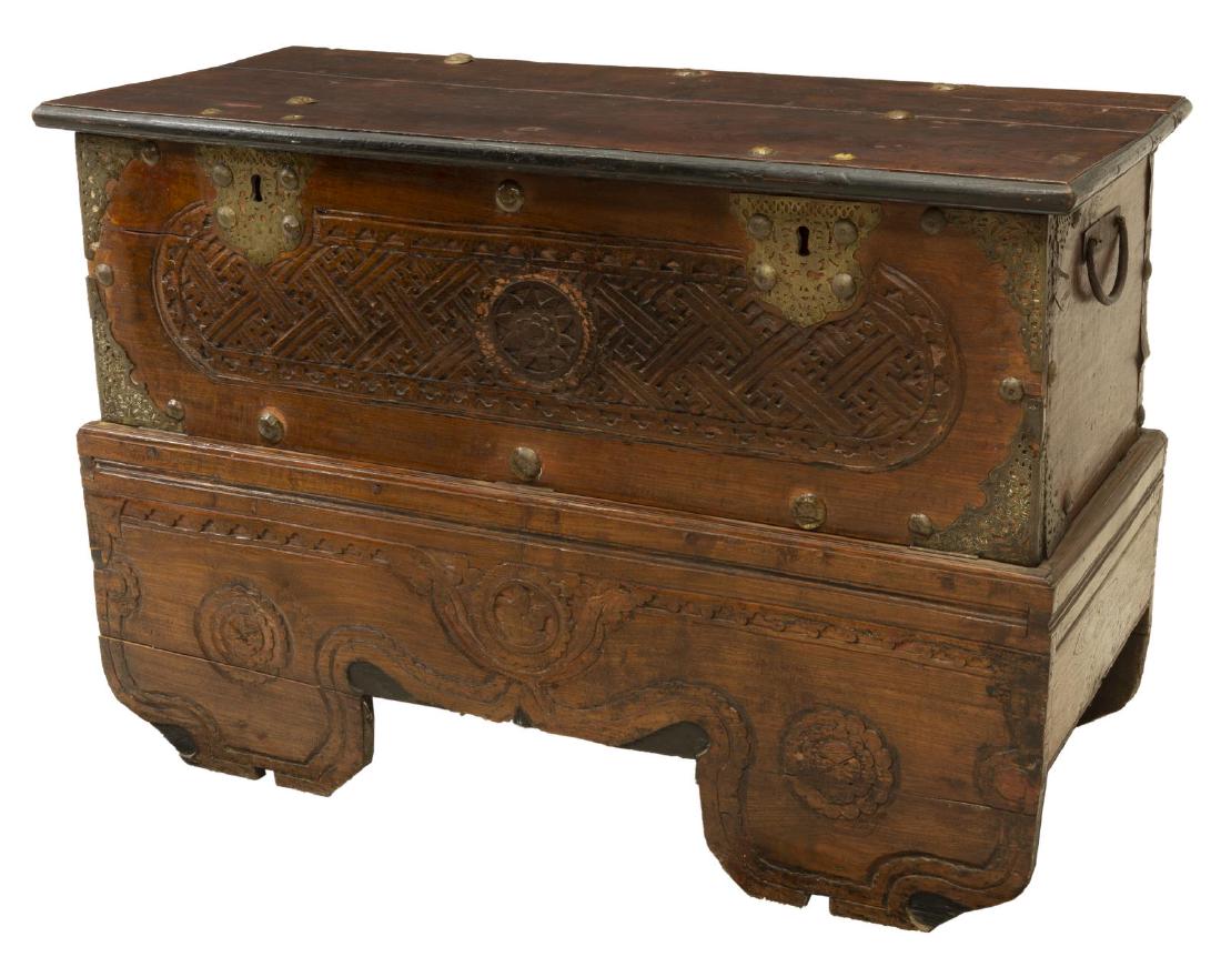 LARGE SOUTHEAST ASIAN HARDWOOD COFFER TRUNK: Southeast Asian hardwood coffer/ trunk, hinged top, open interior, drop-front panel with carved fretwork, iron carrying handles at sides, decorative pierced brass corner mounts and lock plates, carved