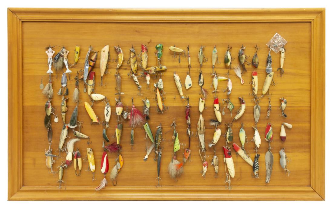 (86) VINTAGE FISHING LURES ON WOOD DISPLAY FRAME: (lot of 86) Substantial vintage collection of fishing lures including glass eyes, wood, spinners and whimsical figures such as (2) mermaid; (2) mouse shaped, all housed on wood display frame, overall: