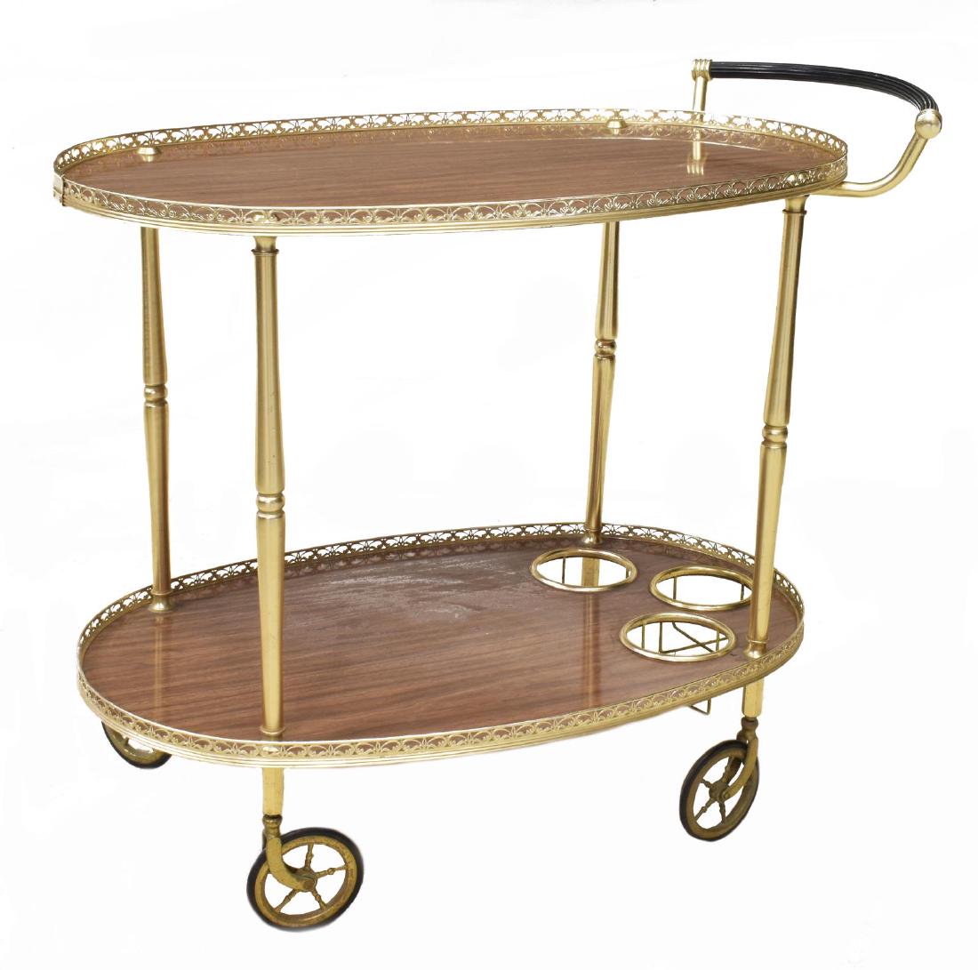 VINTAGE ITALIAN GILT METAL SERVICE CART, 20TH C.: Vintage Italian gilt metal two-tier service cart, 20thc., having pierced railing over laminated top, above one open shelf with three bottle storage, rising on four wheels, approx 26"h, 32"w, 8"d Start