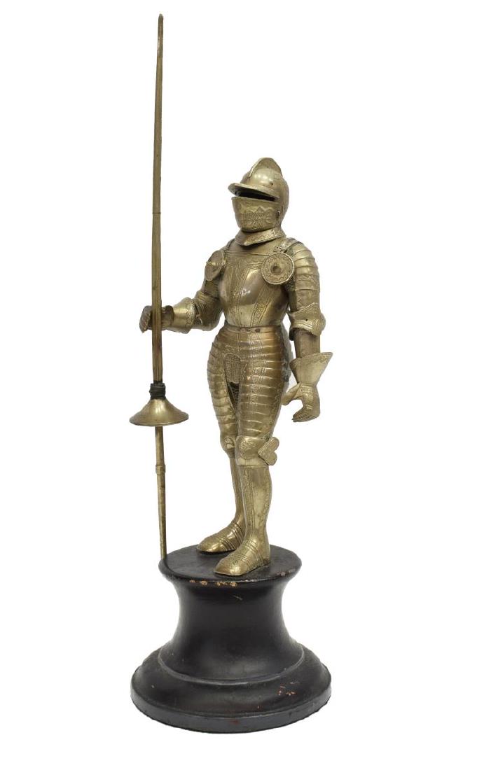 SILVER-TONE METAL STANDING KNIGHT IN ARMOR: Silver-tone metal standing figure of a knight in armor, with close helm, chased breastplate, posed holding a lance, on circular base, approx 14"h, 4.25"diam, 2.75lbs Start Price: $80.00