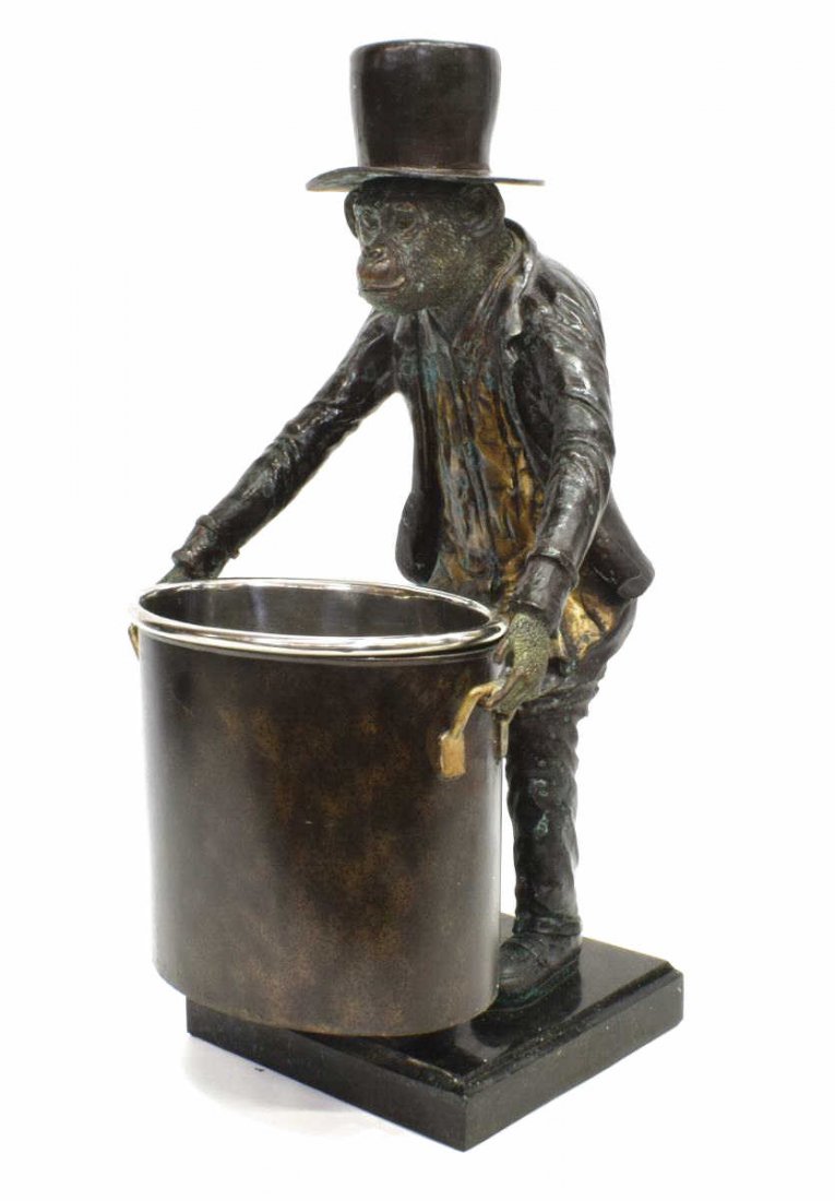 MAITLAND-SMITH BRONZE MONKEY WINE BOTTLE HOLDER: Maitland-Smith patinated bronze wine bottle holder, having standing monkey in formal apparel, holding coated metal ice bucket with insert, standing on marble base, retaining manufacturer's sticker, ap